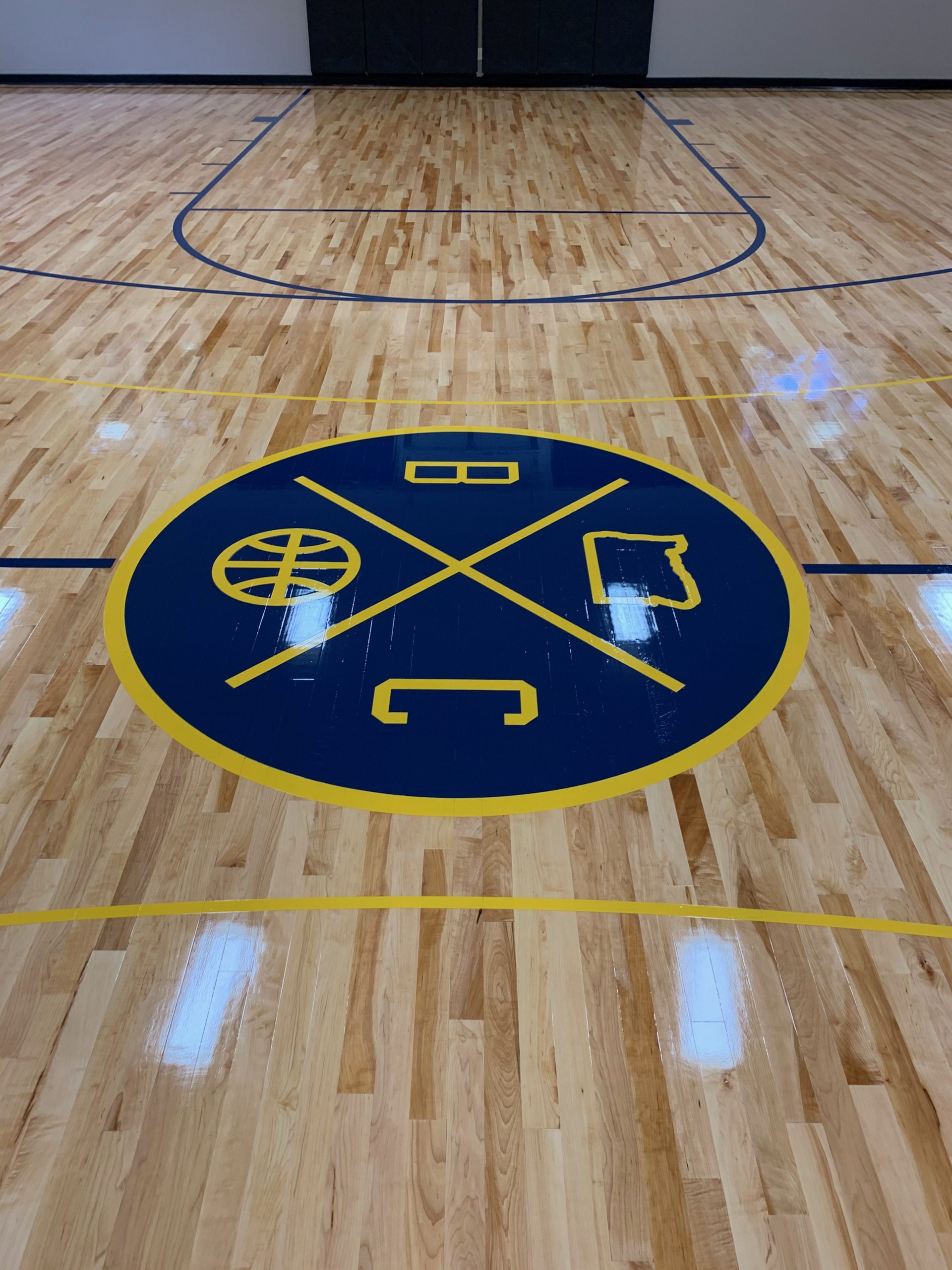 Personal home basketball court - new installation of 2nd and better maple flooring. Then sanded and sealed with two coats of our hybrid sealer, followed by game lines, logos, and two coats of high gloss oil-modified finish