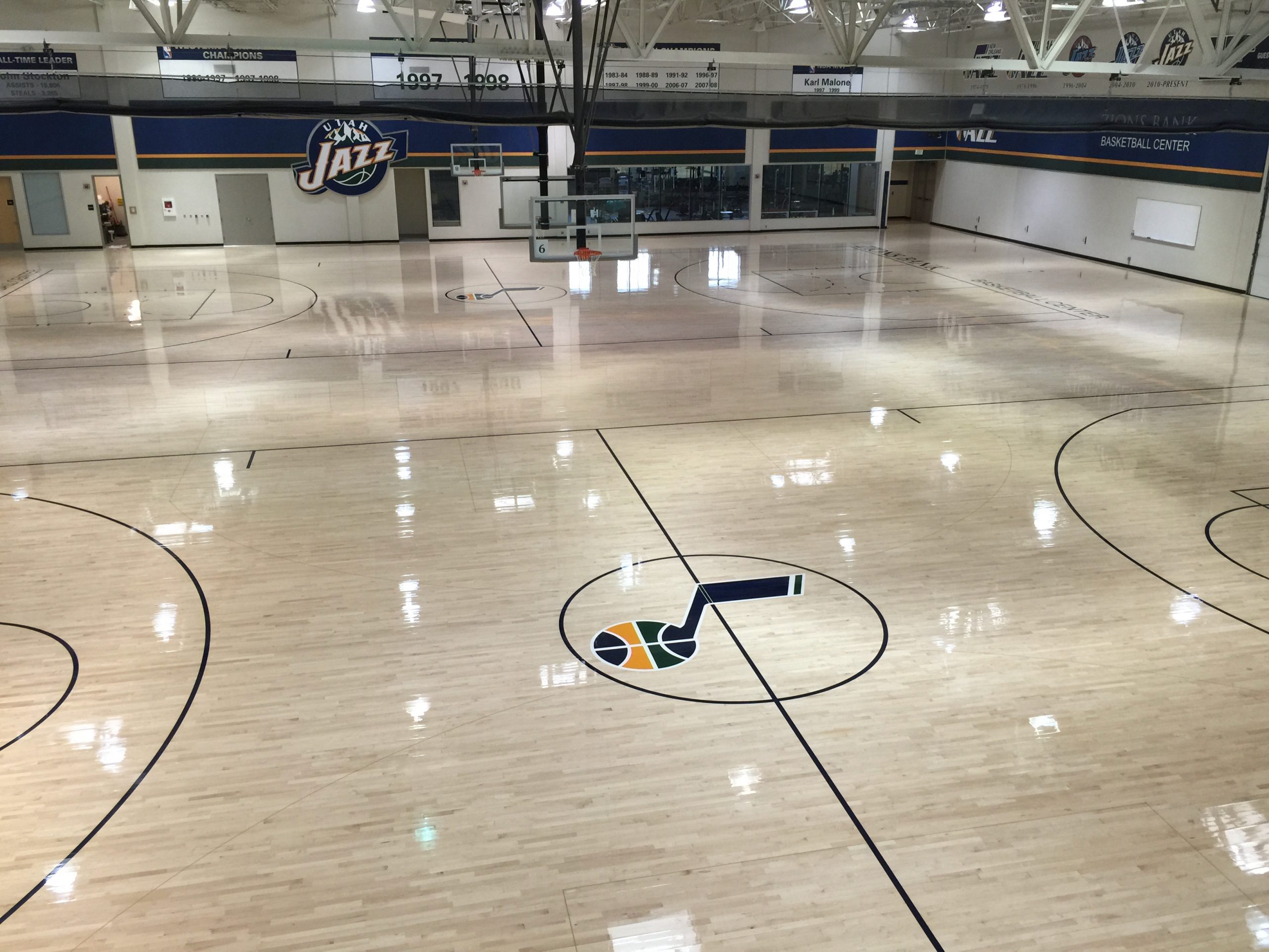 Utah Jazz Practice Facility, Salt Lake City, Utah - full drum sanding and refinishing of their gym floor by COURTSPORTS. Design, stencils, and all paintwork provided by COURTSPORTS.