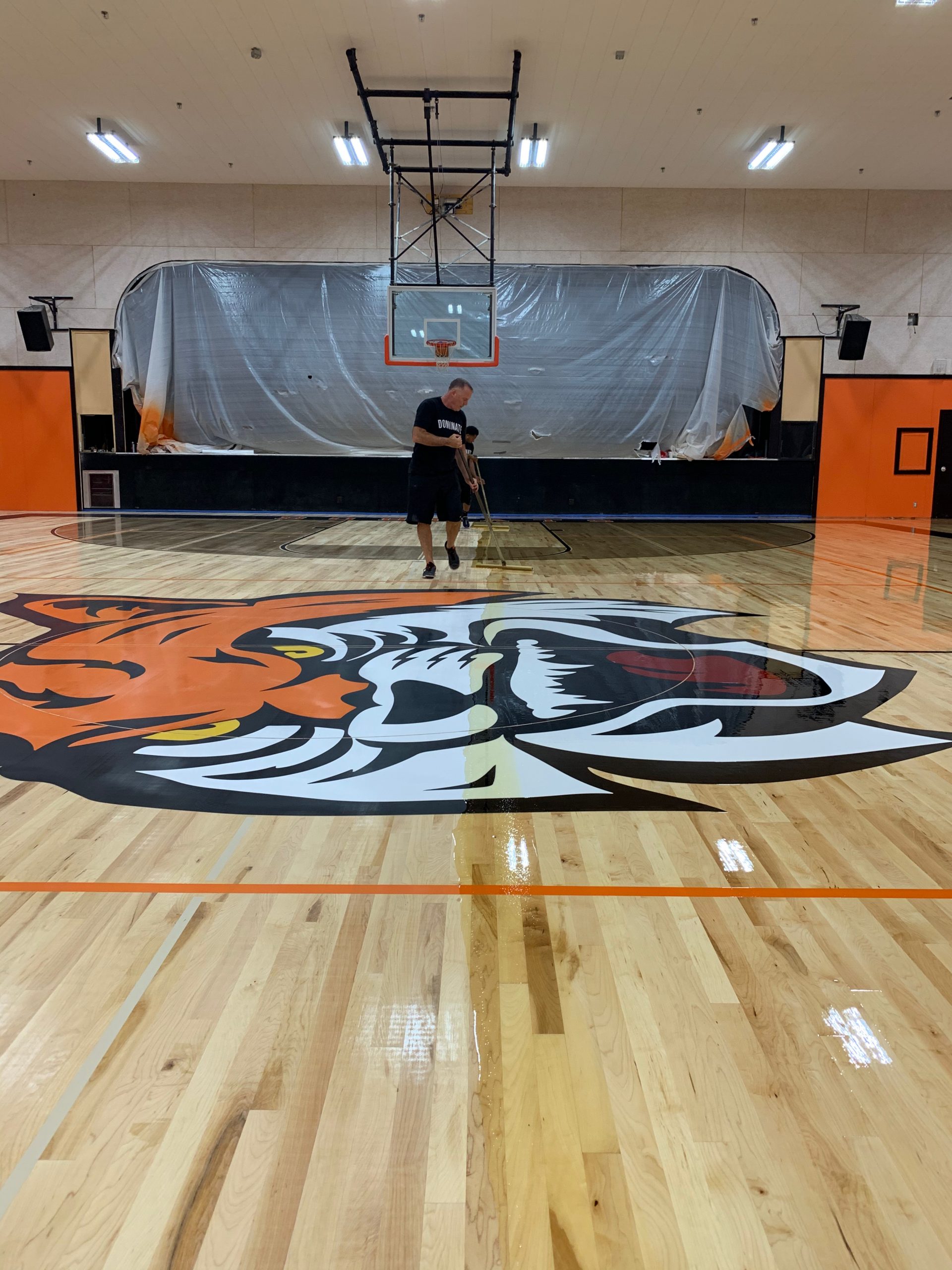 New maple basketball court installation. Followed by sanding, two sealer coats, game lines & logos, and two final coats of oil-modified urethane.