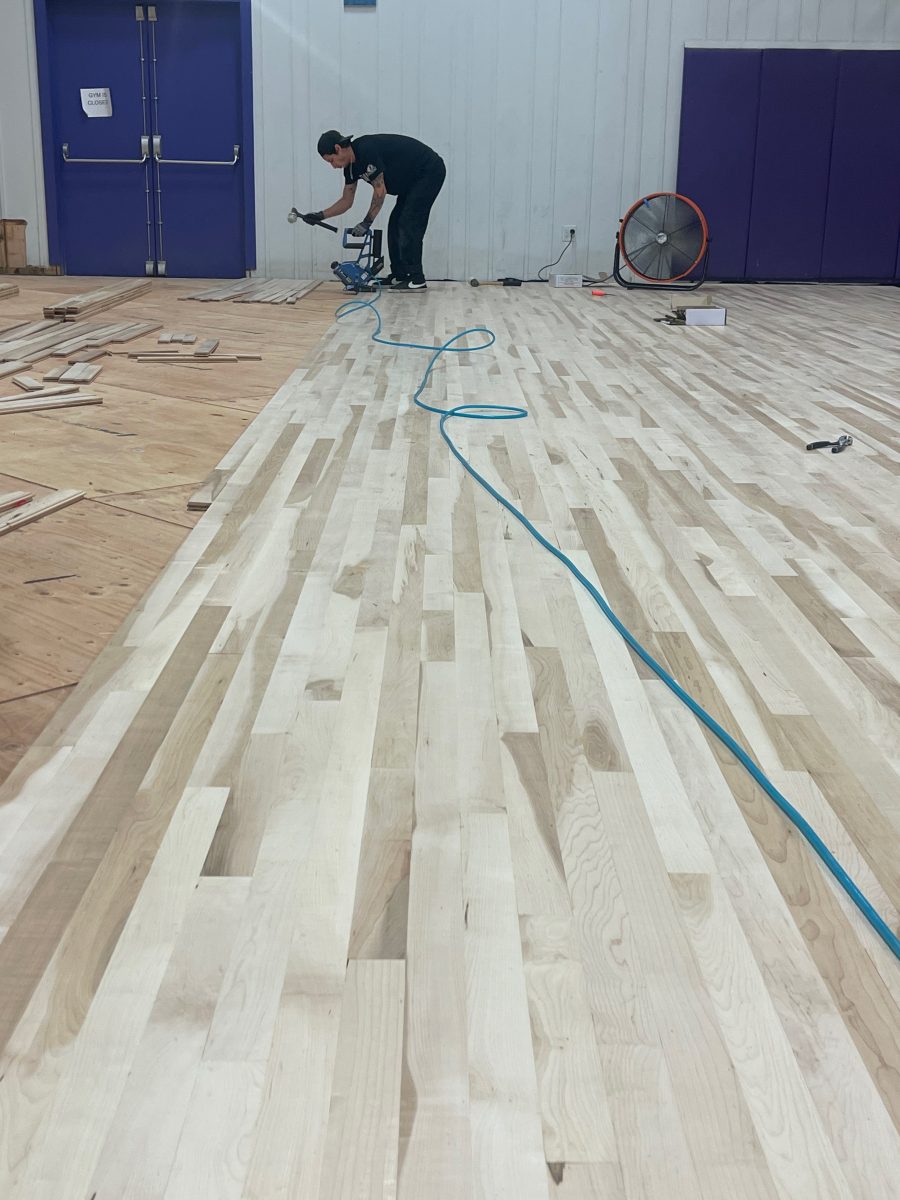 New sub floor and maple flooring begin nailed by COURTSPORTS.